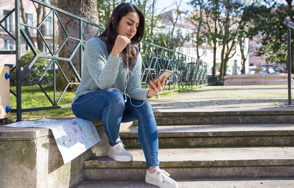 serious-pretty-woman-listening-music-city-stairs-parapet